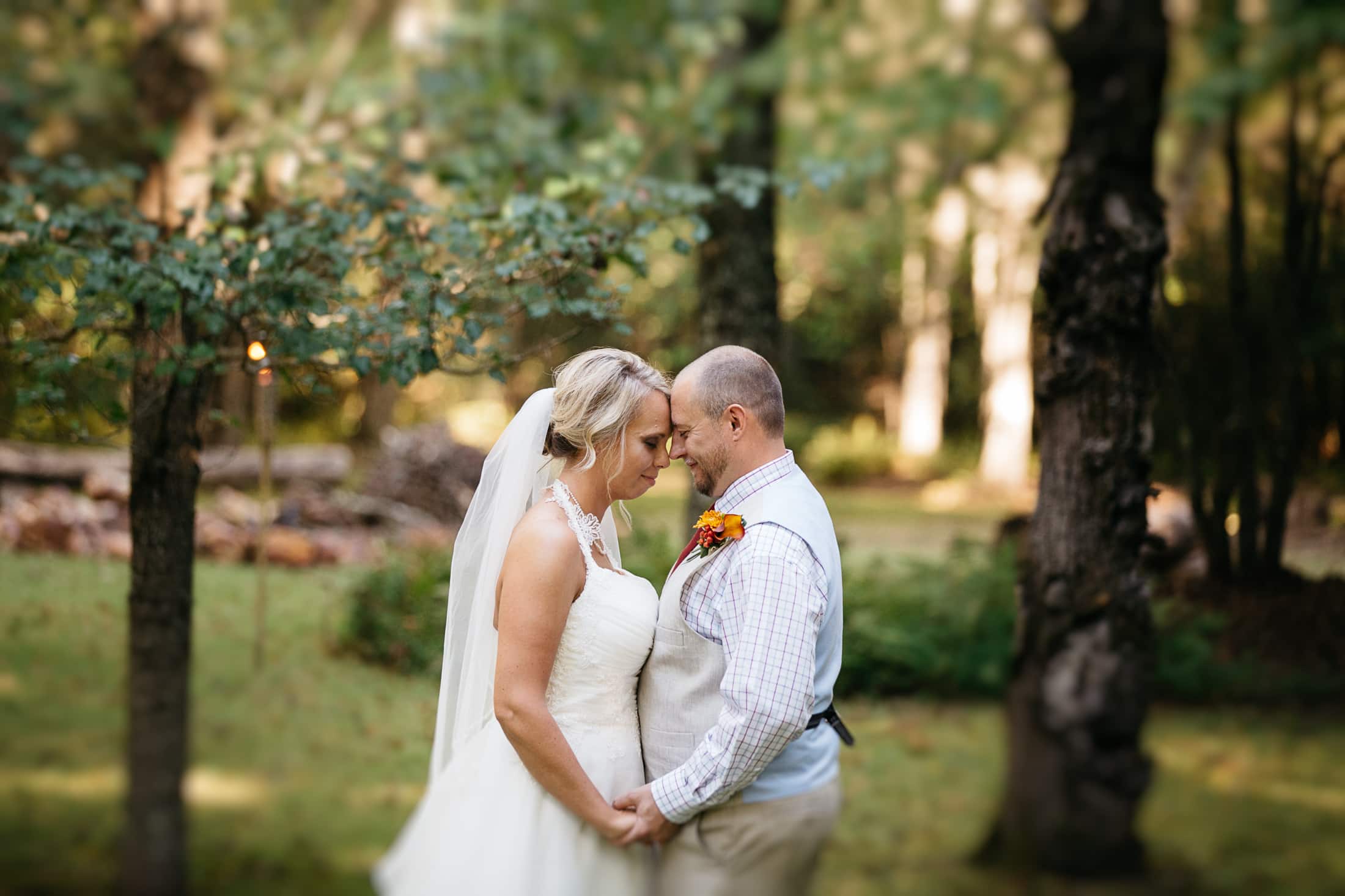 Bride and Groom holding hands at outdoor wedding in the fall