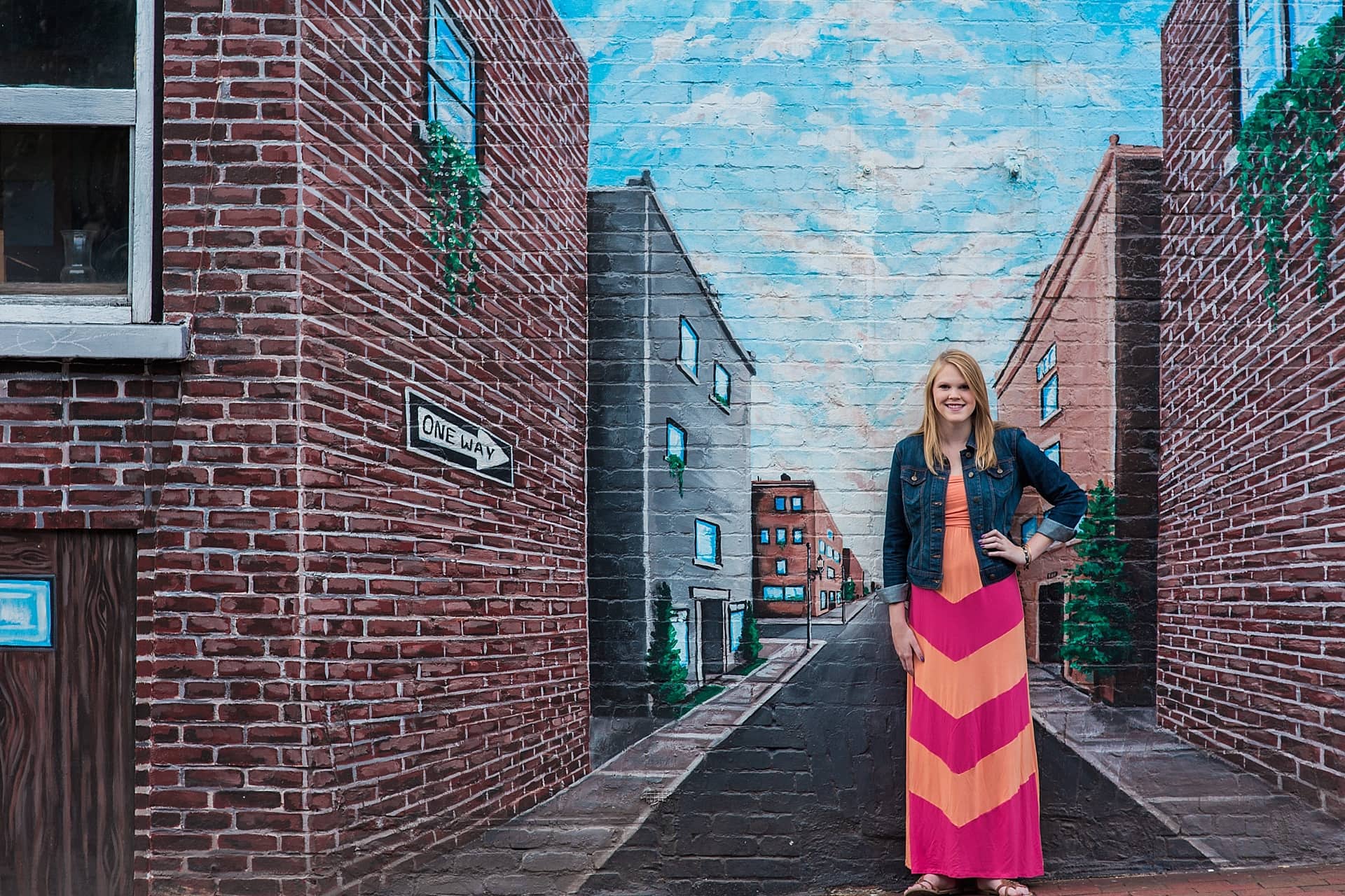 High school senior portrait in front of mural in downtown Asheville NC