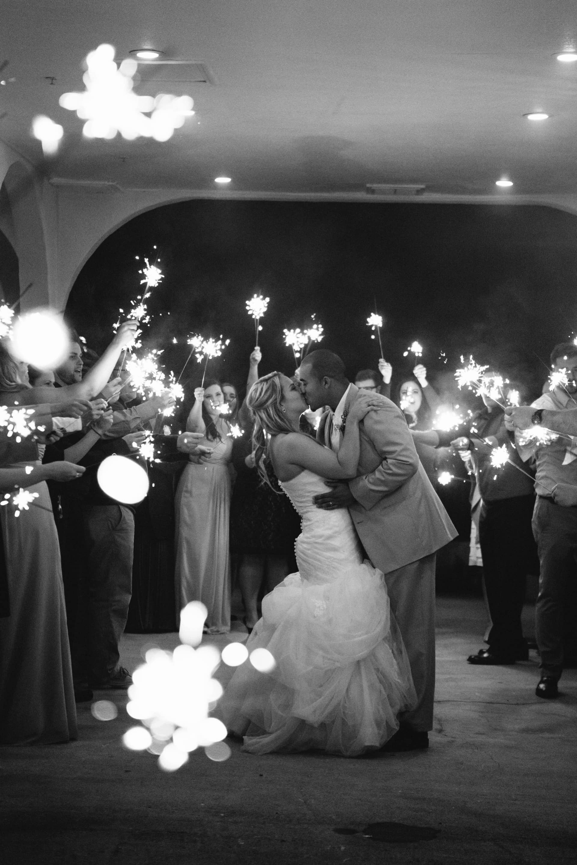 bride and groom kiss at sparkler send off