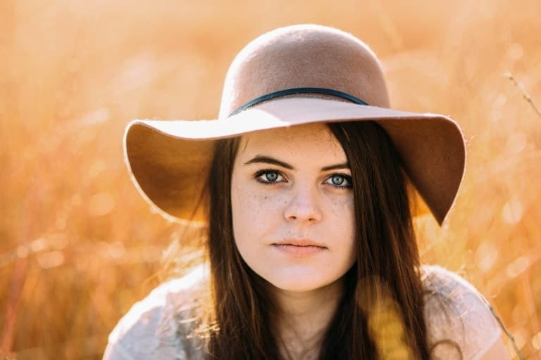 Girl in floppy hat at sunrise