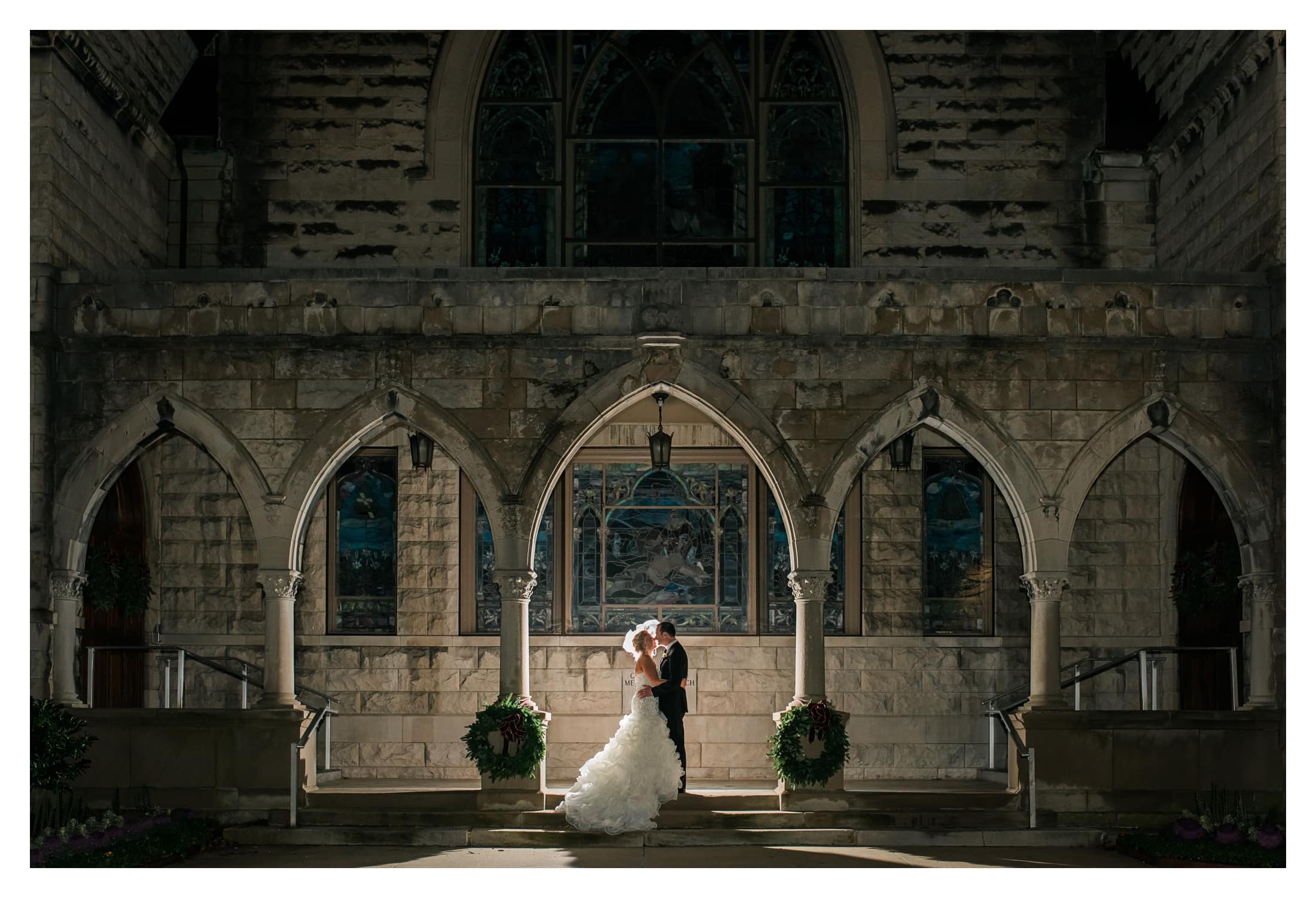 Asheville Destination Wedding, Wedding photography at night, Bride and groom under archway at night, Asheville Downtown Night Wedding Portraits