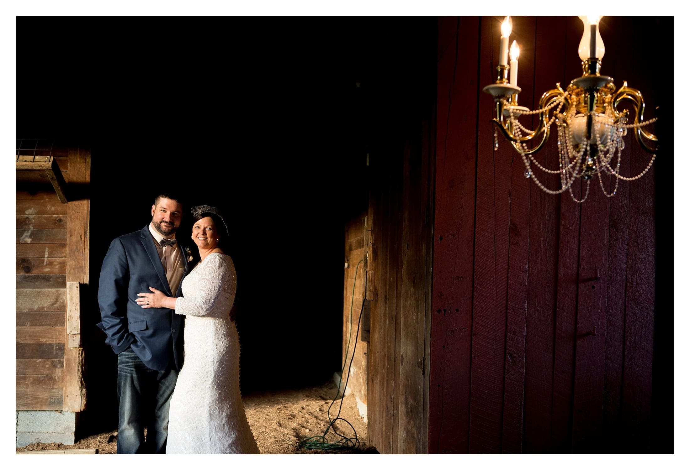 Couple in barn with chandelier