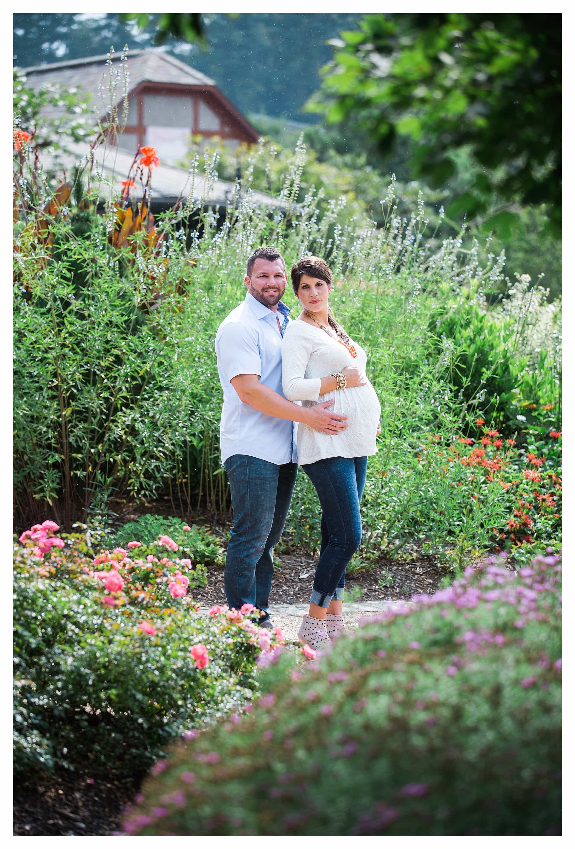 Couple standing in front of summer flowers