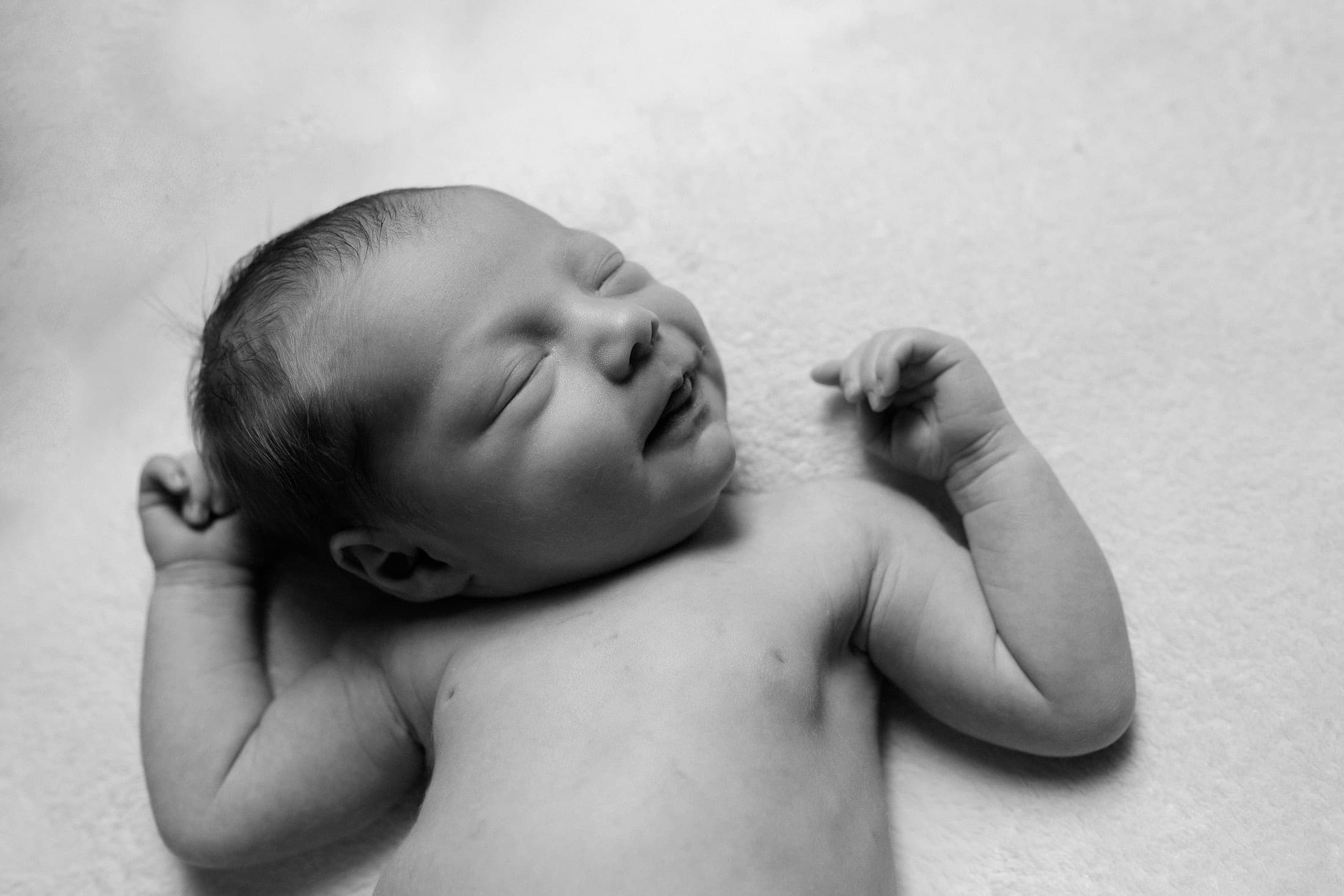 Black and white photograph of smailing baby