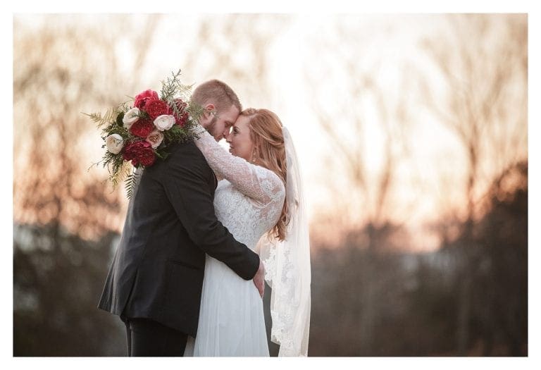 Orange sunset sky in mountains of NC with bride and groom