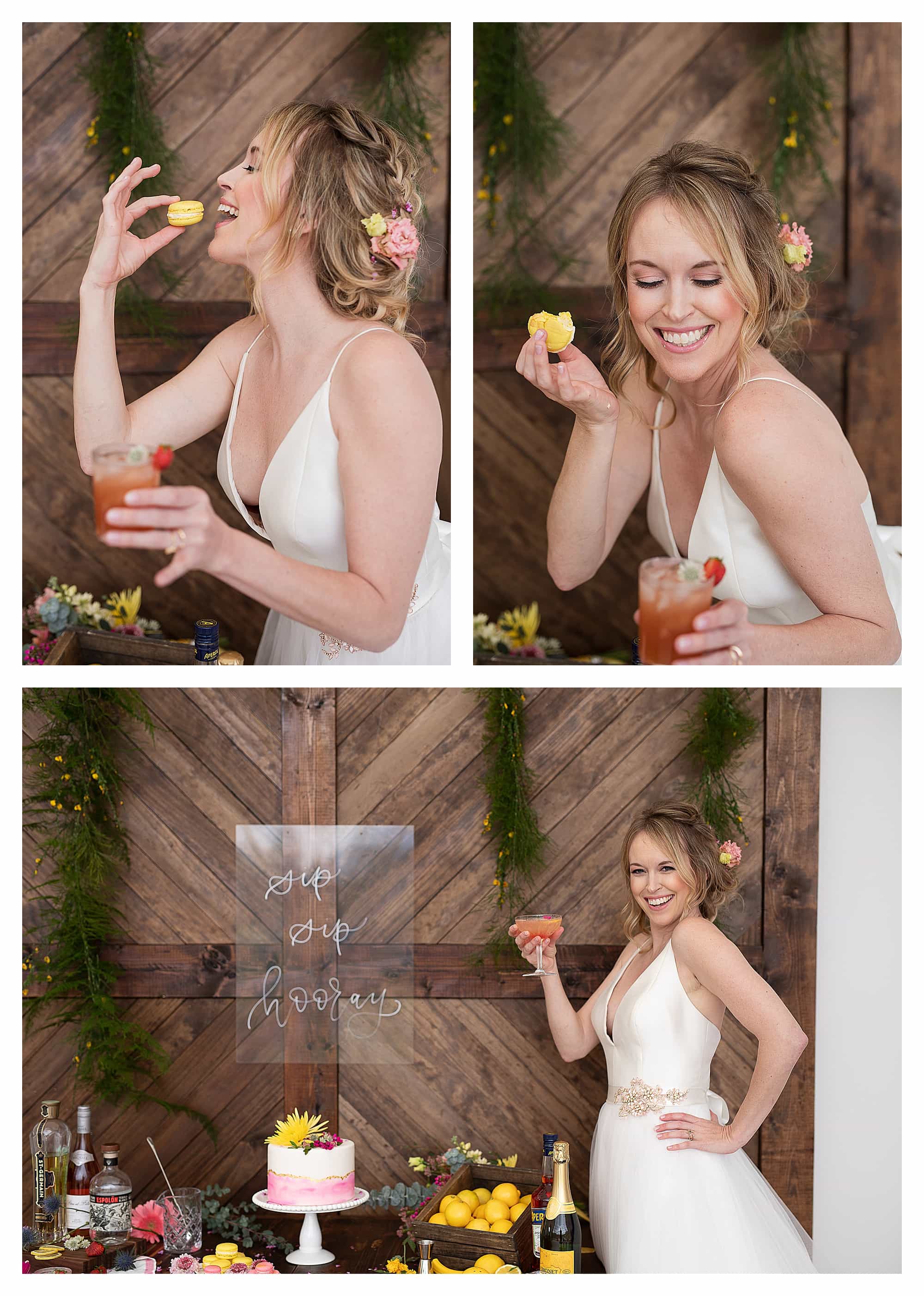 Bride in wedding dress laughing while drinking cocktail and eating yellow macarons beside beautiful wedding cake
