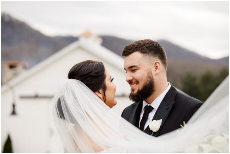 Veil Photo with bride and groom with venue in background