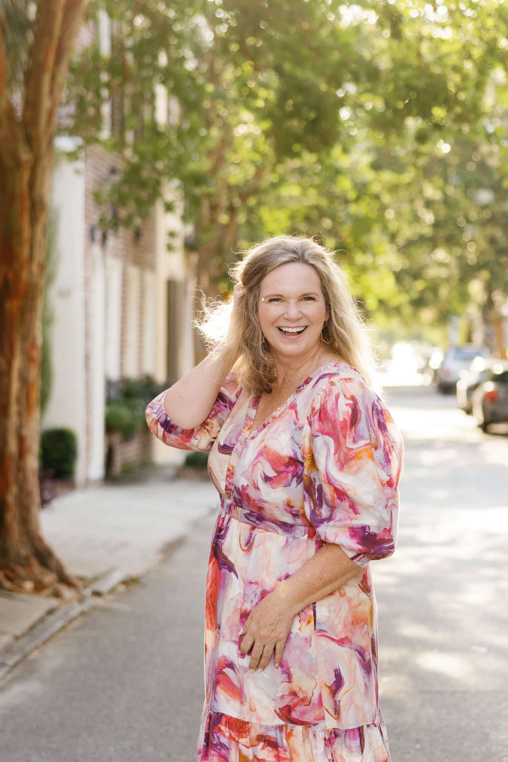 A woman in a floral dress on a street in Charleston, South Carolina.