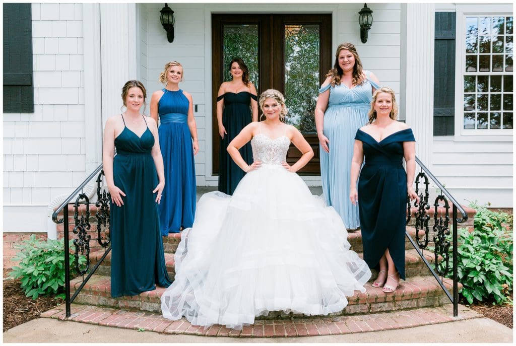 The bride with her bridesmaids before leaving for their venue. The bridesmaids all wore different colored dresses.
