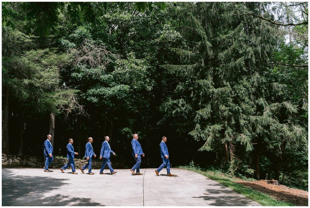 Beatles inspired photo of groomsmen walking across a path at Honeysuckle Hill.