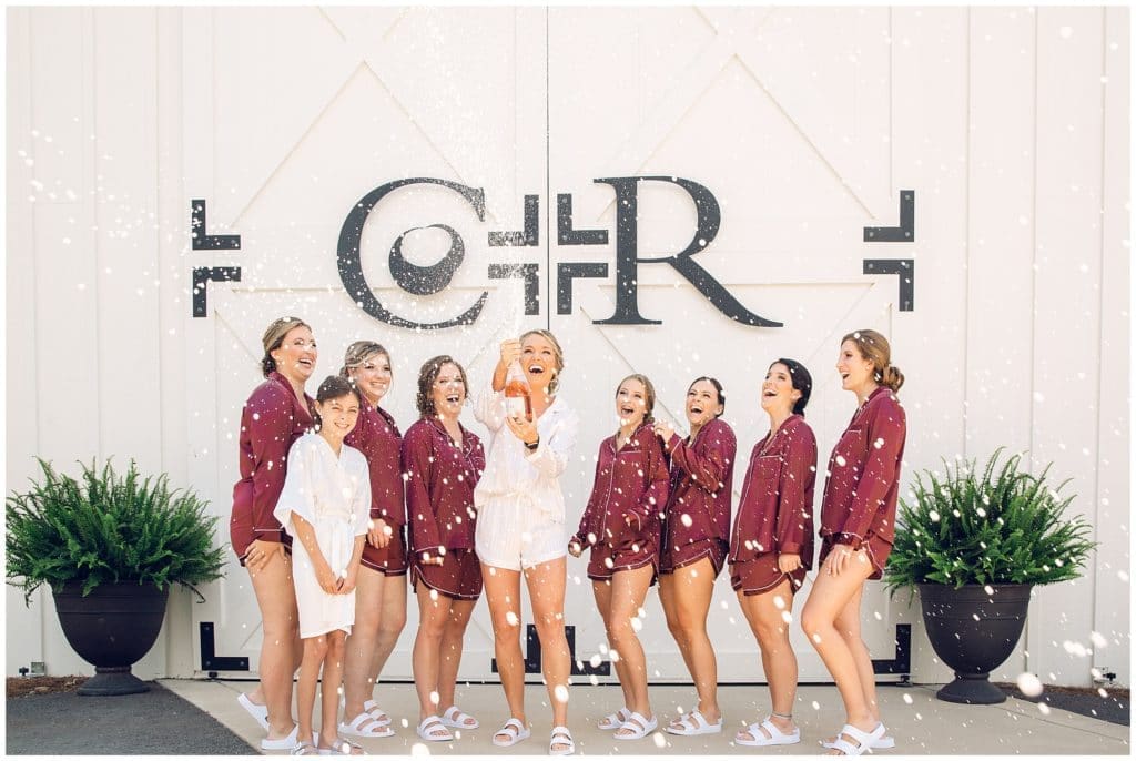 Champagne pop in matching pajamas with Bridesmaids at Chestnut Ridge | Asheville Wedding Photographer | Kathy Beaver Photography