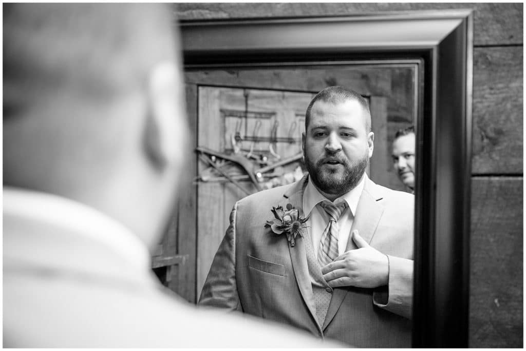 Black and white portrait of the groom getting ready in the mirror | Asheville Wedding Photographer