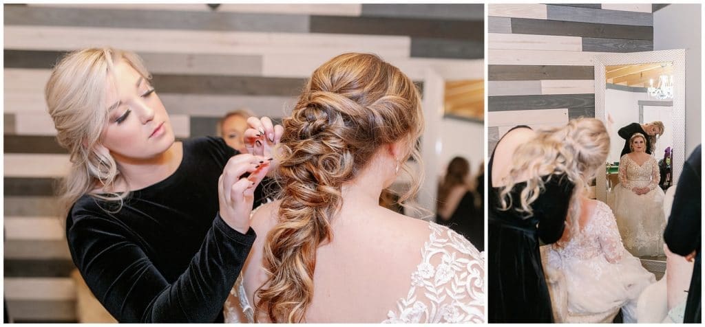 A bridesmaid helps pin the bride's hair into a long ponytail with curls while getting ready  | Asheville Wedding Photographer