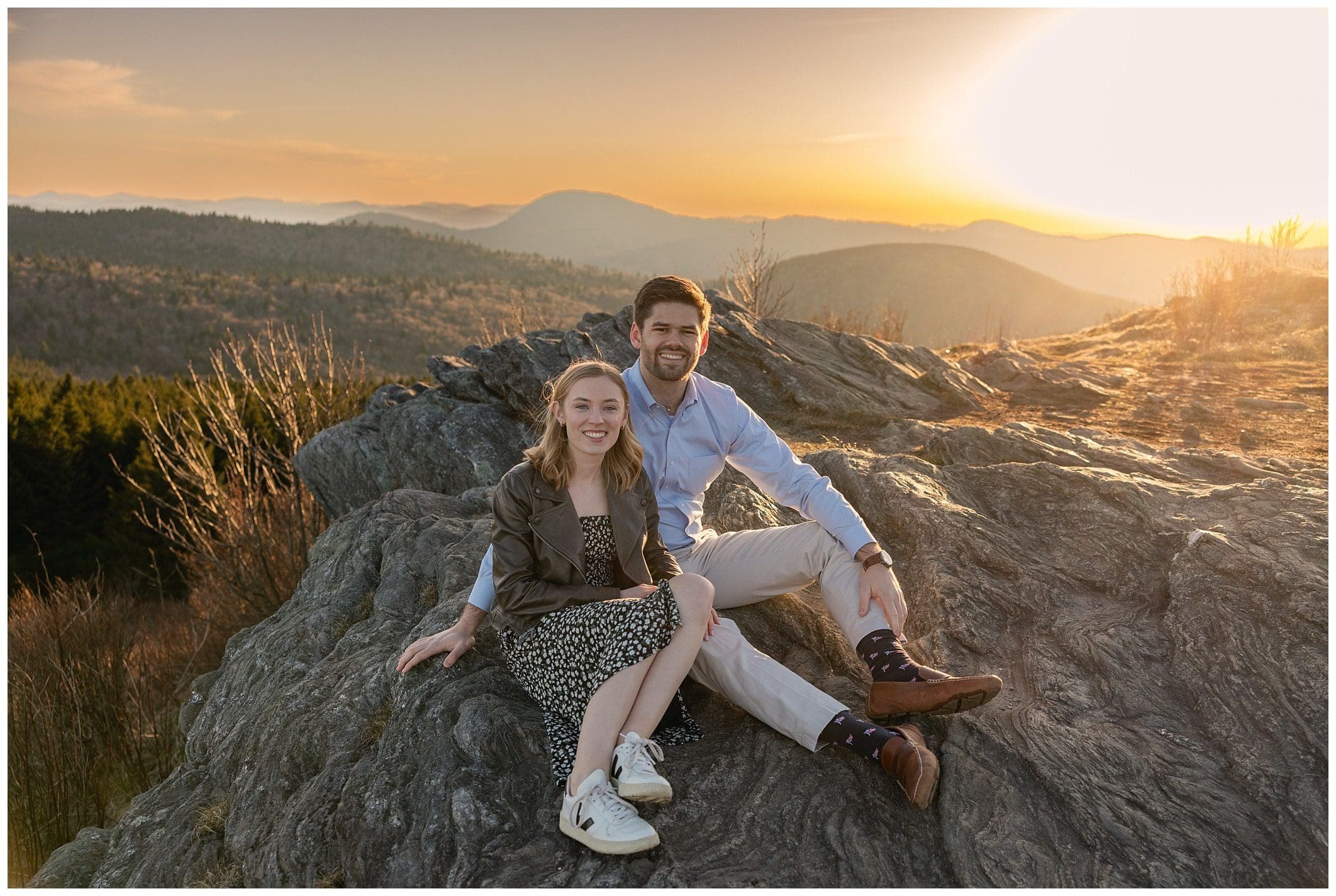 couple sits on a rock with mountain views for their Black Balsam engagement session