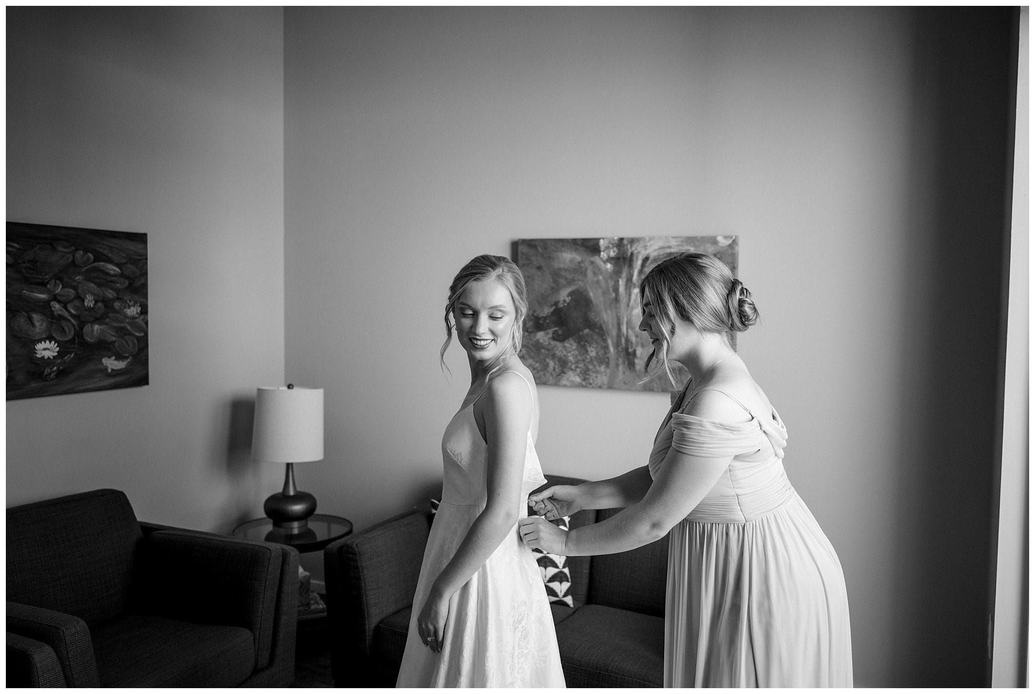 bride gets into her dress for her downtown Asheville wedding