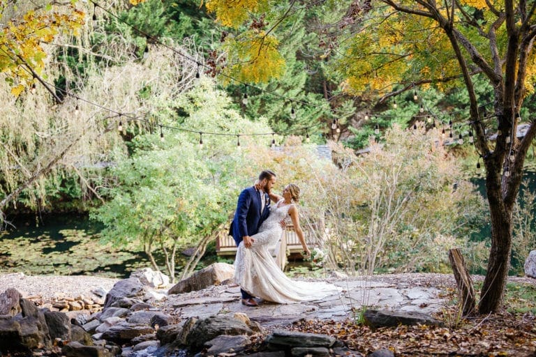 groom dips bride surrounded by fall colors at Honeysuckle Hill Wedding Venue