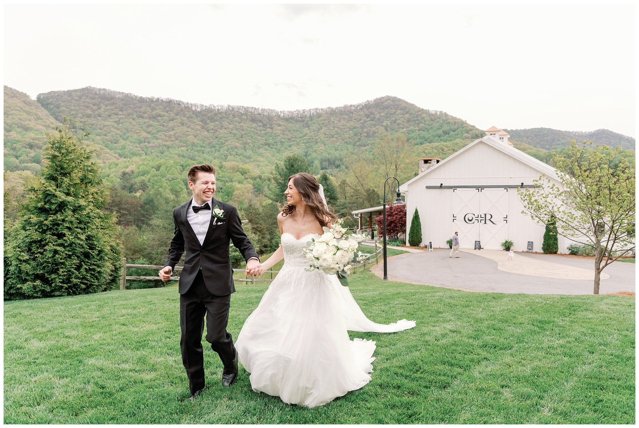 Bride and groom hold hands while running on thier wedding day photos by Kathy Beaver Asheville Wedding Photographer 