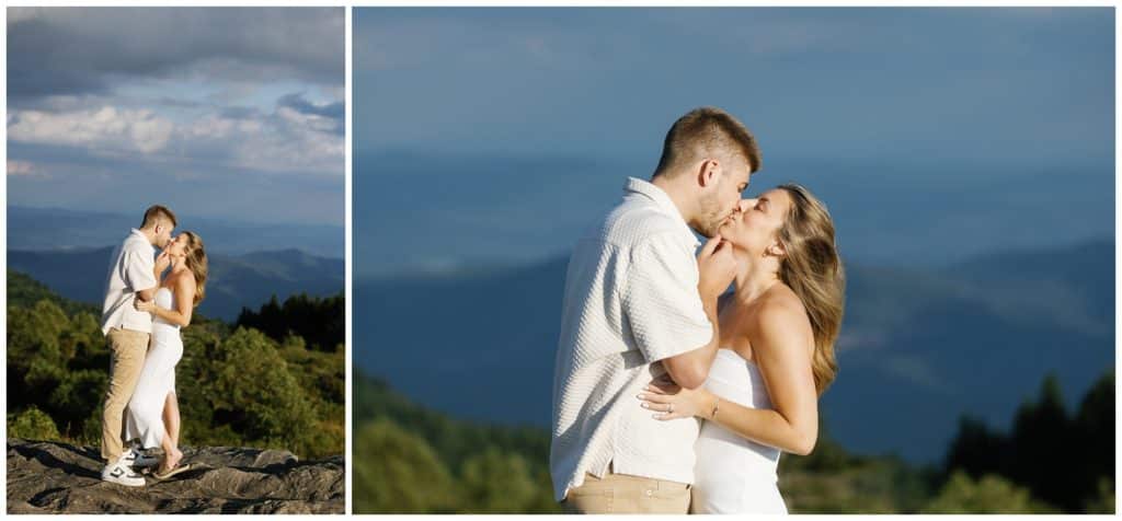 An engaged couple kissing on top of a mountain.