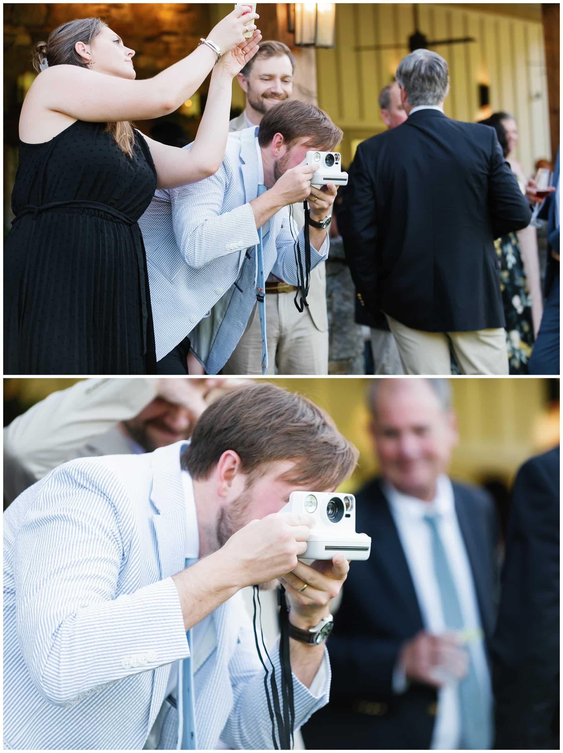 A man takes a picture with a camera at a wedding reception.