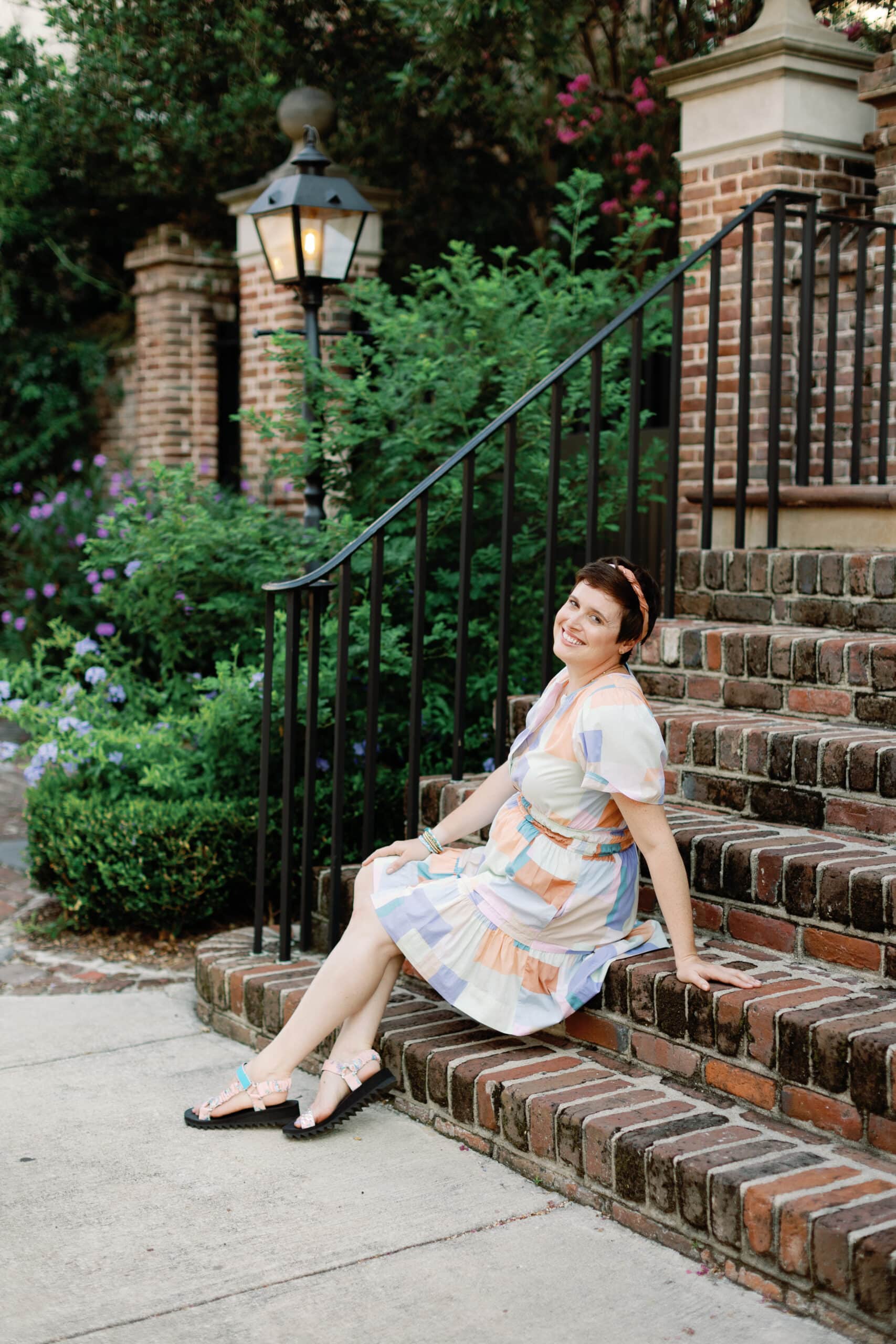 A woman participating in the 2024 Winter Content Creation Retreat, sitting on the steps of a building.