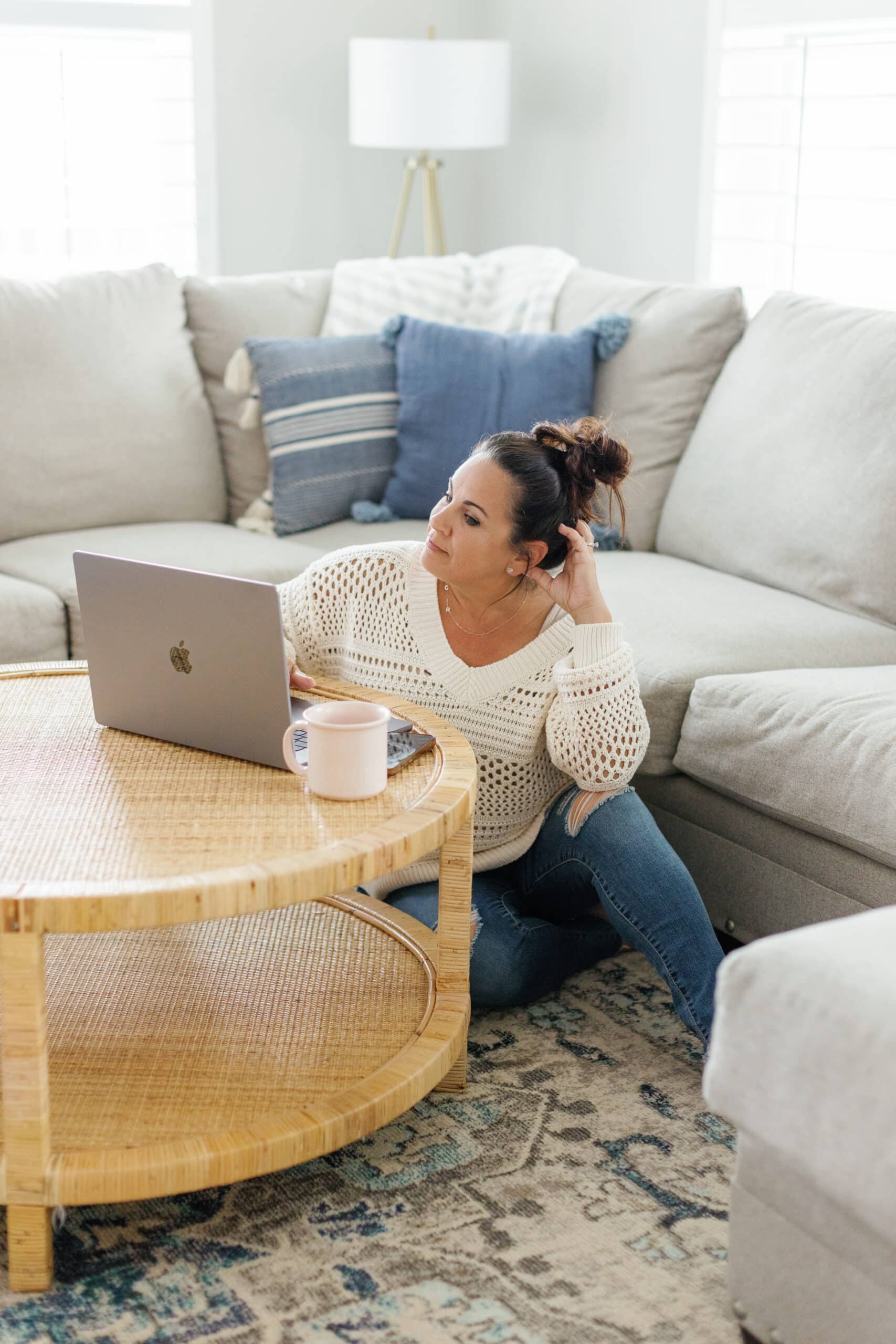 A woman creatively working on her laptop during the 2024 Winter Content Creation Retreat.