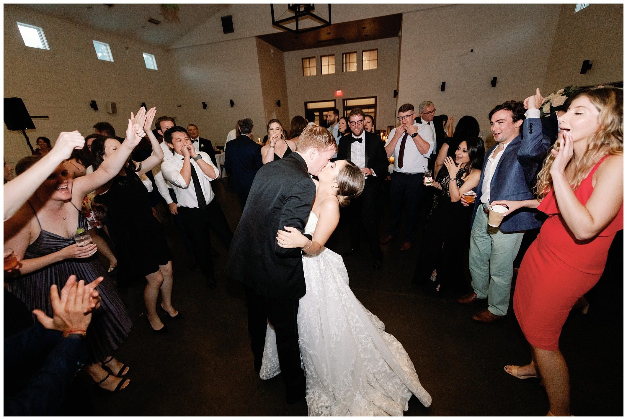 A bride and groom kissing at their wedding reception.