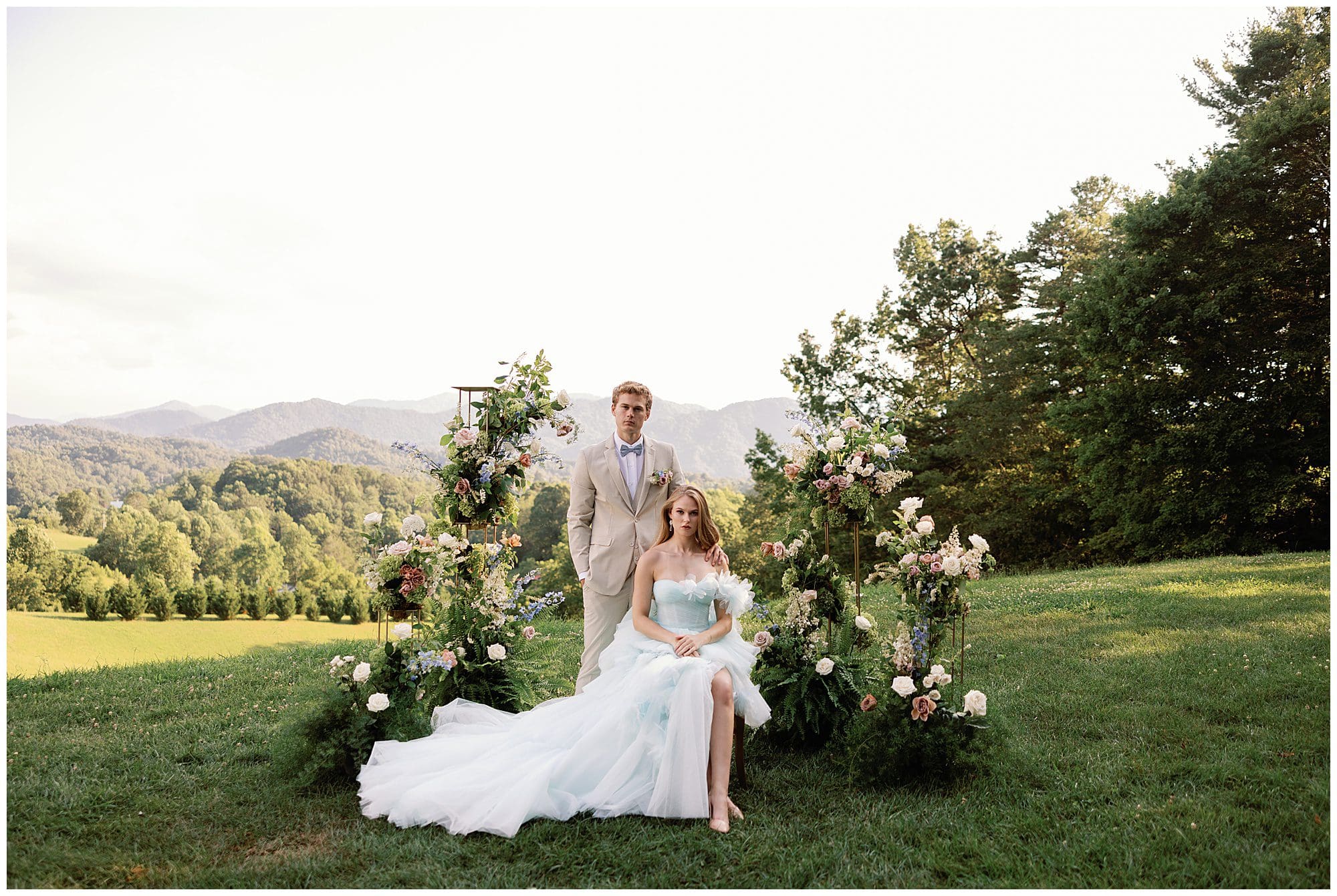 A Parisian-inspired summer wedding at The Ridge with a bride and groom posing for a photo amidst the mountains.