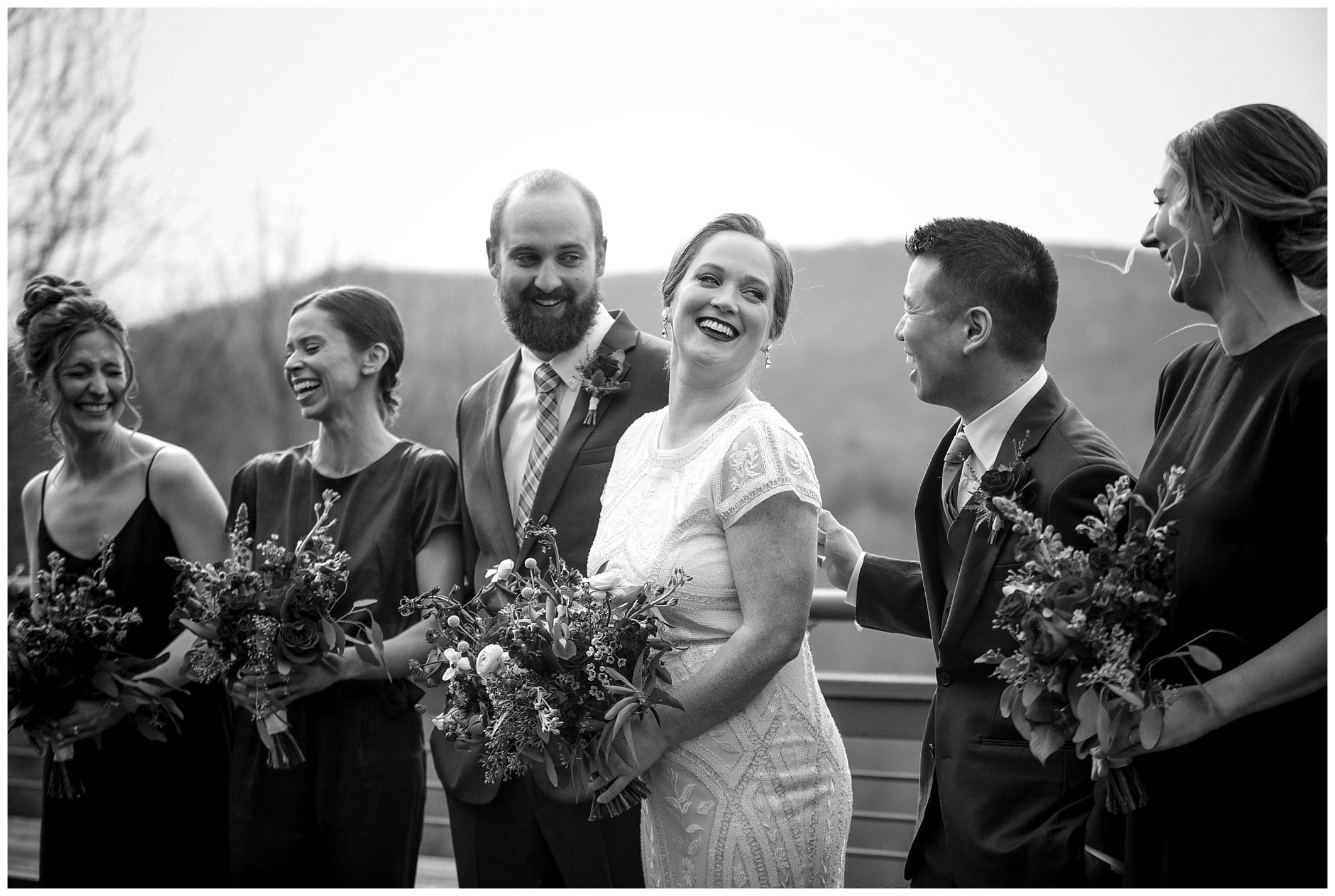 A black and white photo of bridesmaids laughing.