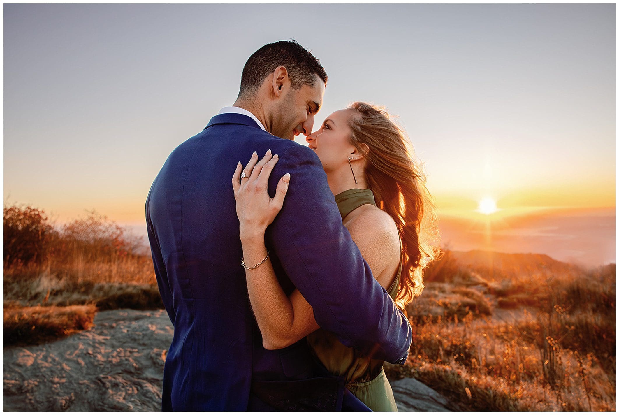 Couple embracing at sunrise with scenic black balsam view.