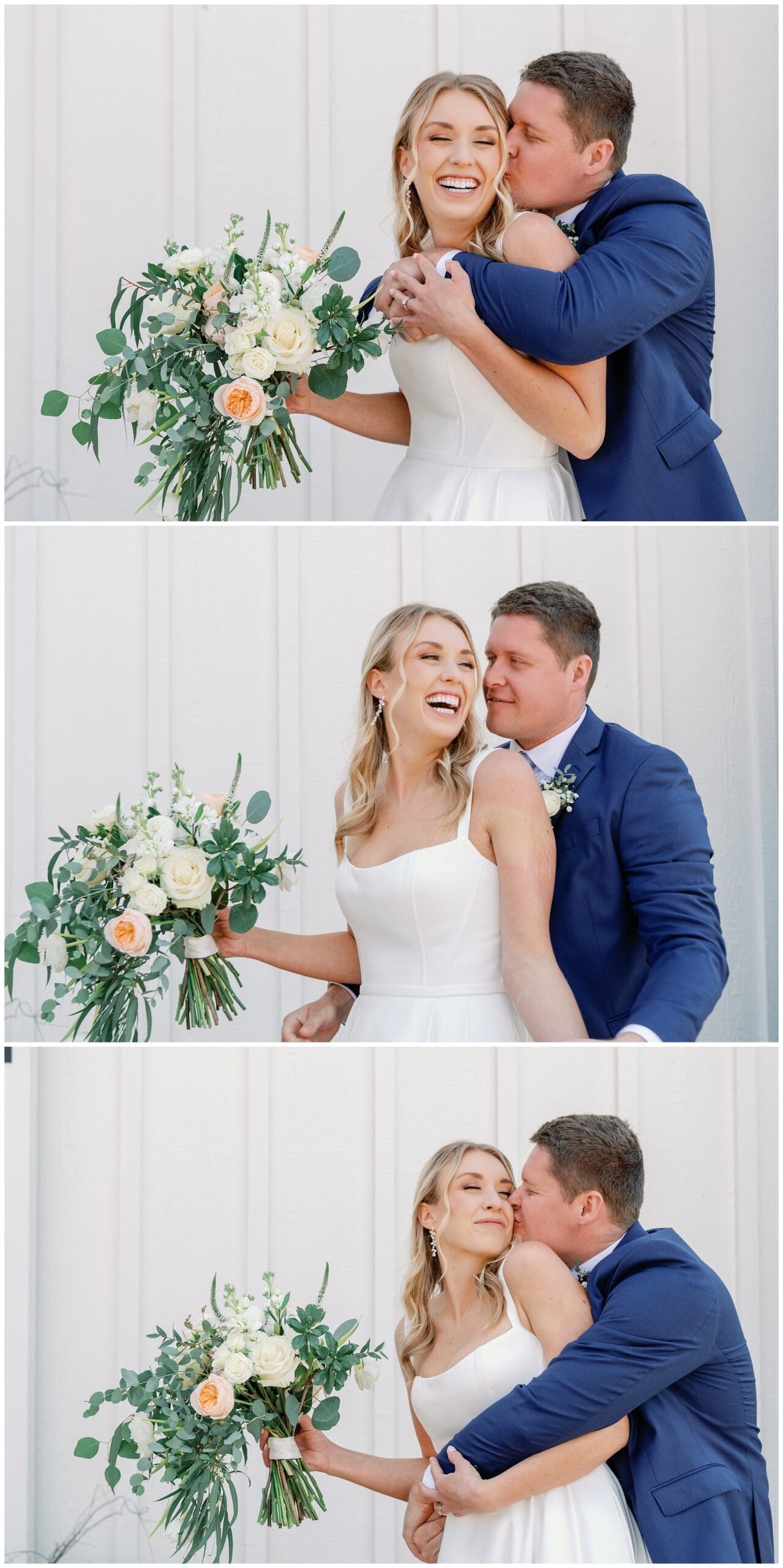 A bride and groom kissing in front of a white wall.