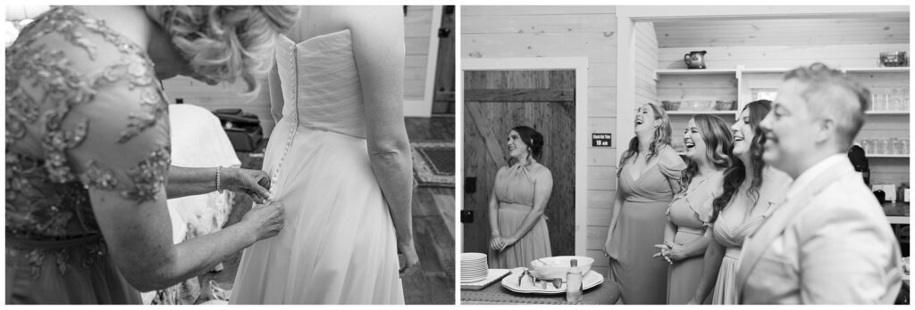 A person is fastening the buttons on the back of a wedding dress. Nearby, a group of bridesmaids in formal attire are standing and smiling. The scene takes place indoors with wooden walls.