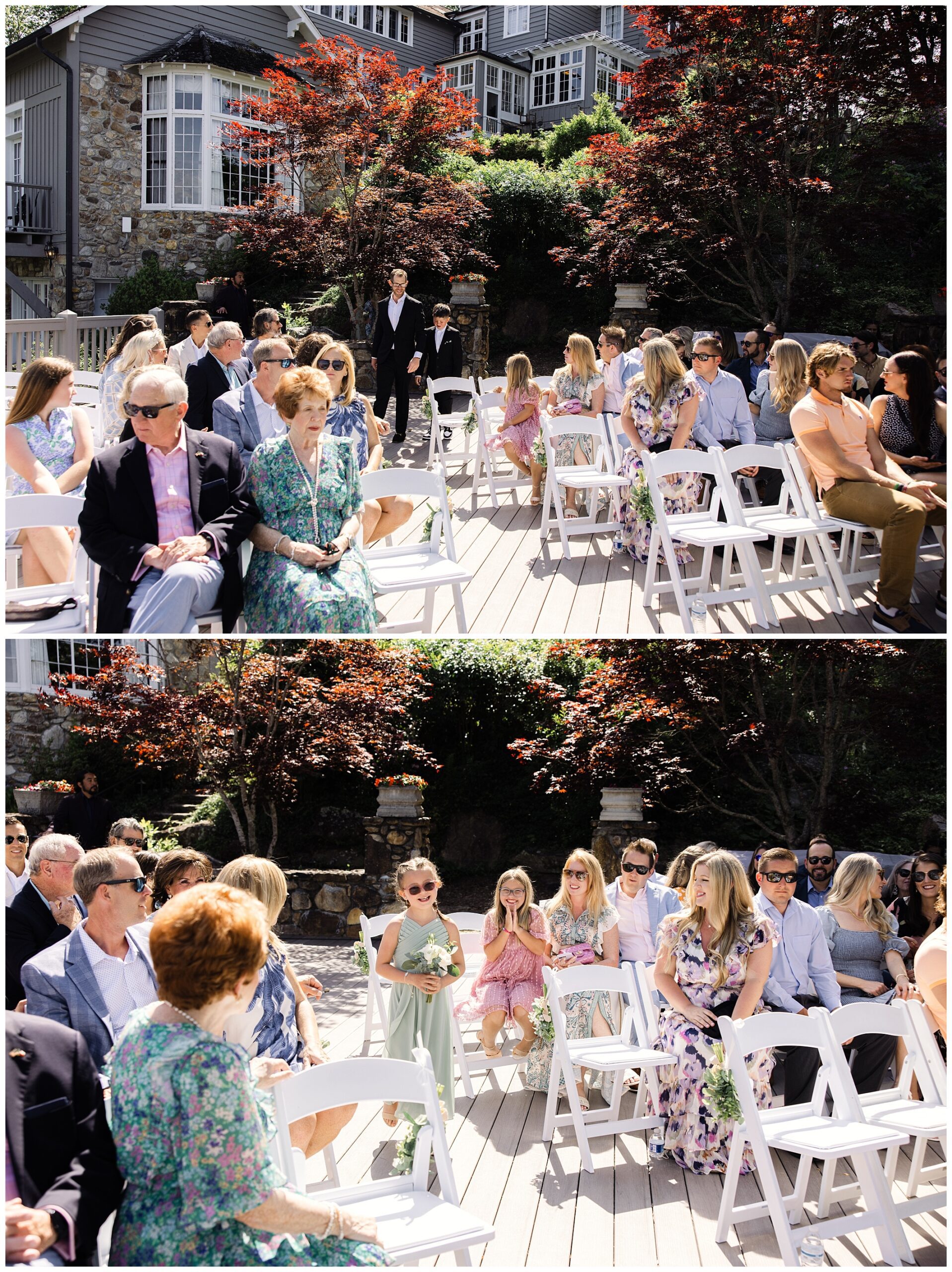 Guests seated outdoors on white chairs at a formal event. Some people are engaged in conversation while others look towards the camera. A house and garden can be seen in the background.