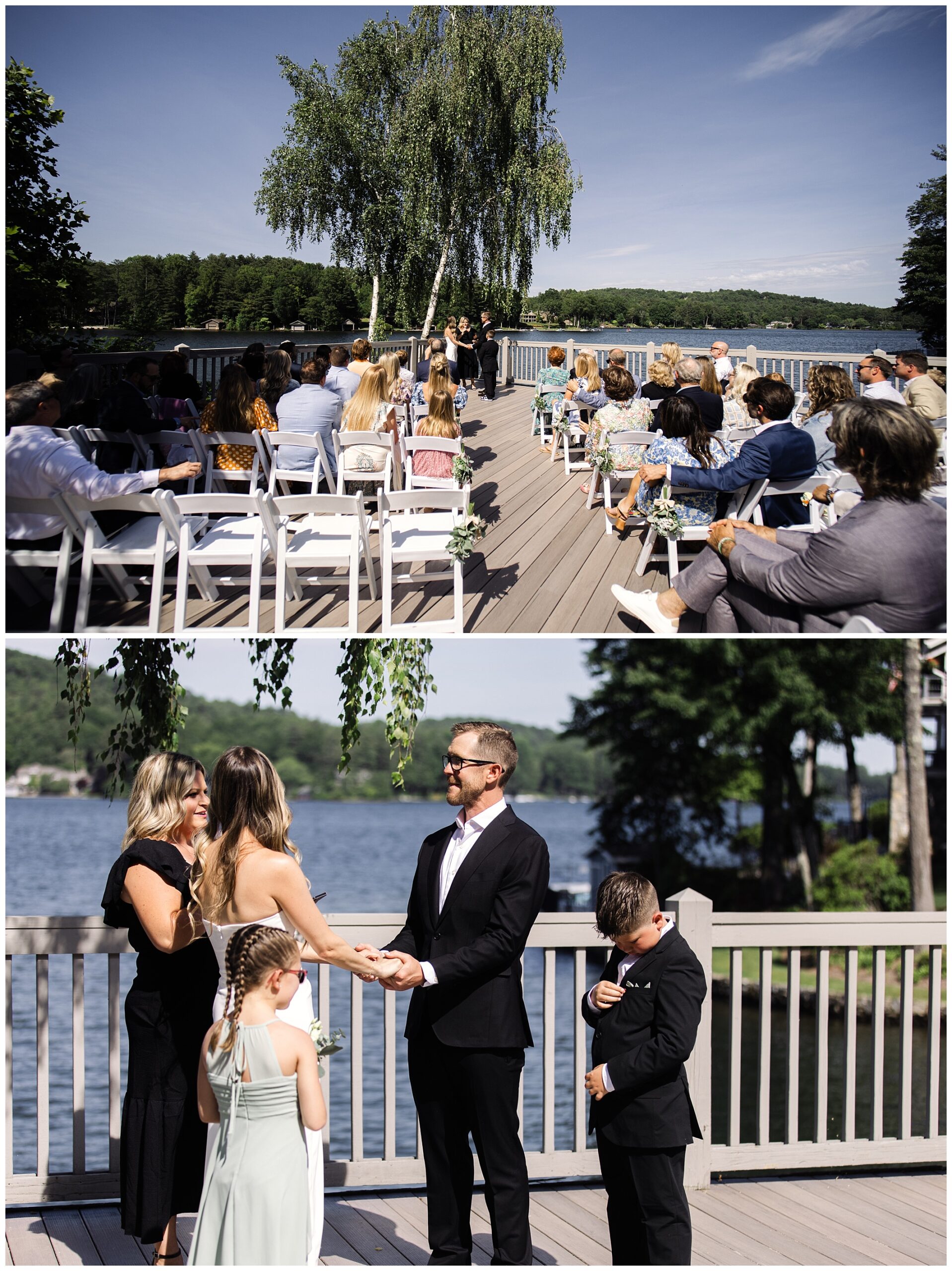 A couple exchanges vows and wedding rings on an outdoor deck by a lake, surrounded by seated guests and lush greenery under a clear sky.