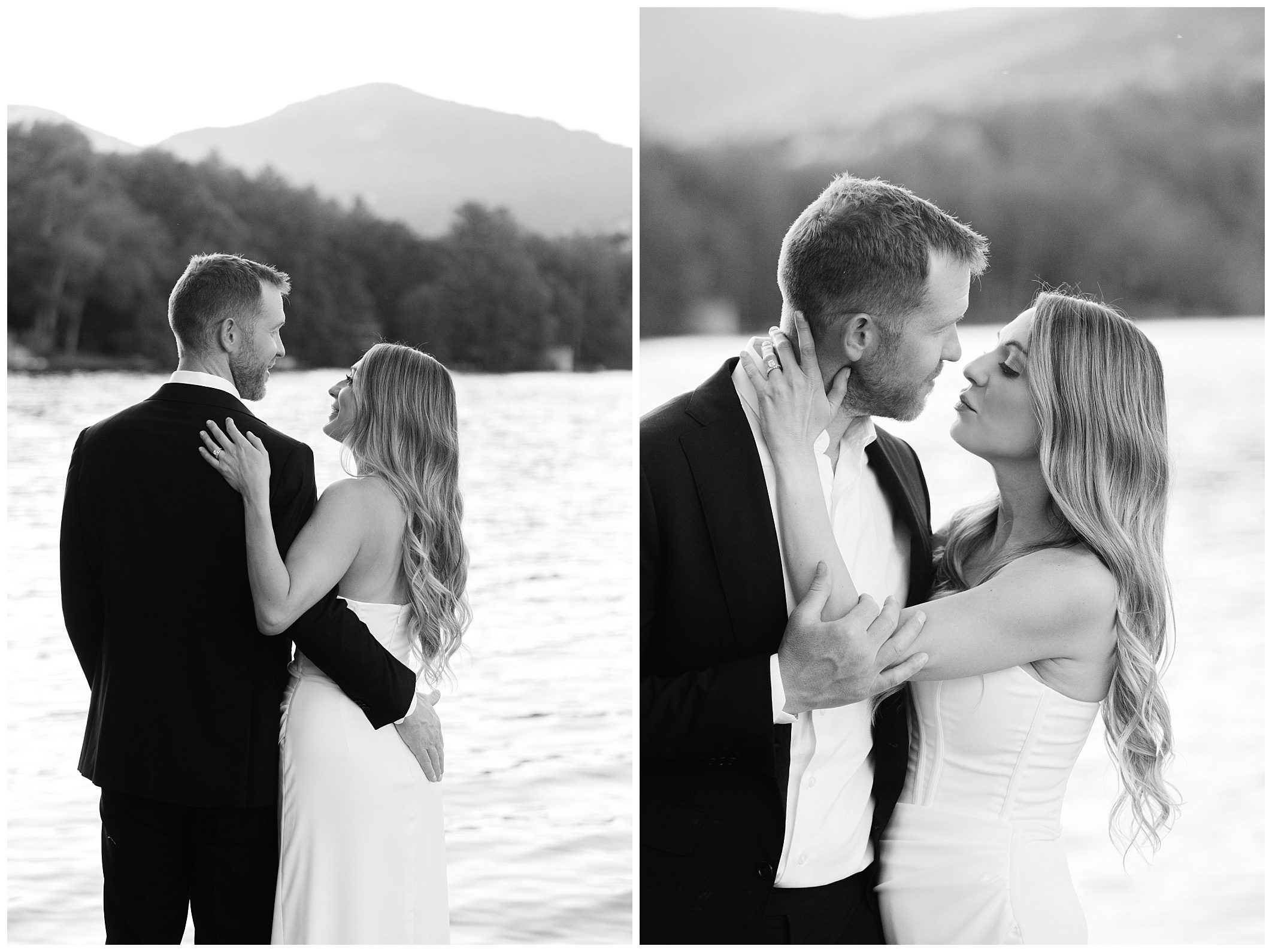 A couple dressed formally stands by a body of water with mountains in the background. They gaze at each other and embrace. Black and white photo. at this Intimate Greystone Inn Summer Wedding