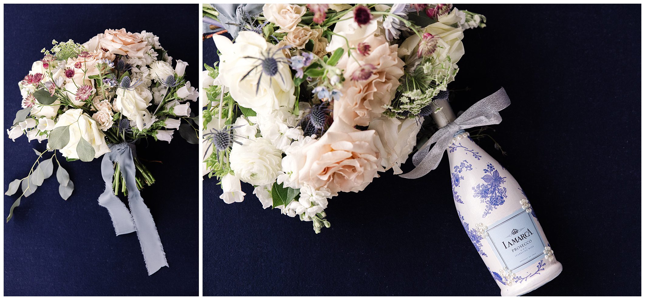 A bottle of LAMARCA wine lies next to a bouquet of various flowers, including white and beige roses, with a gray ribbon against a dark background.