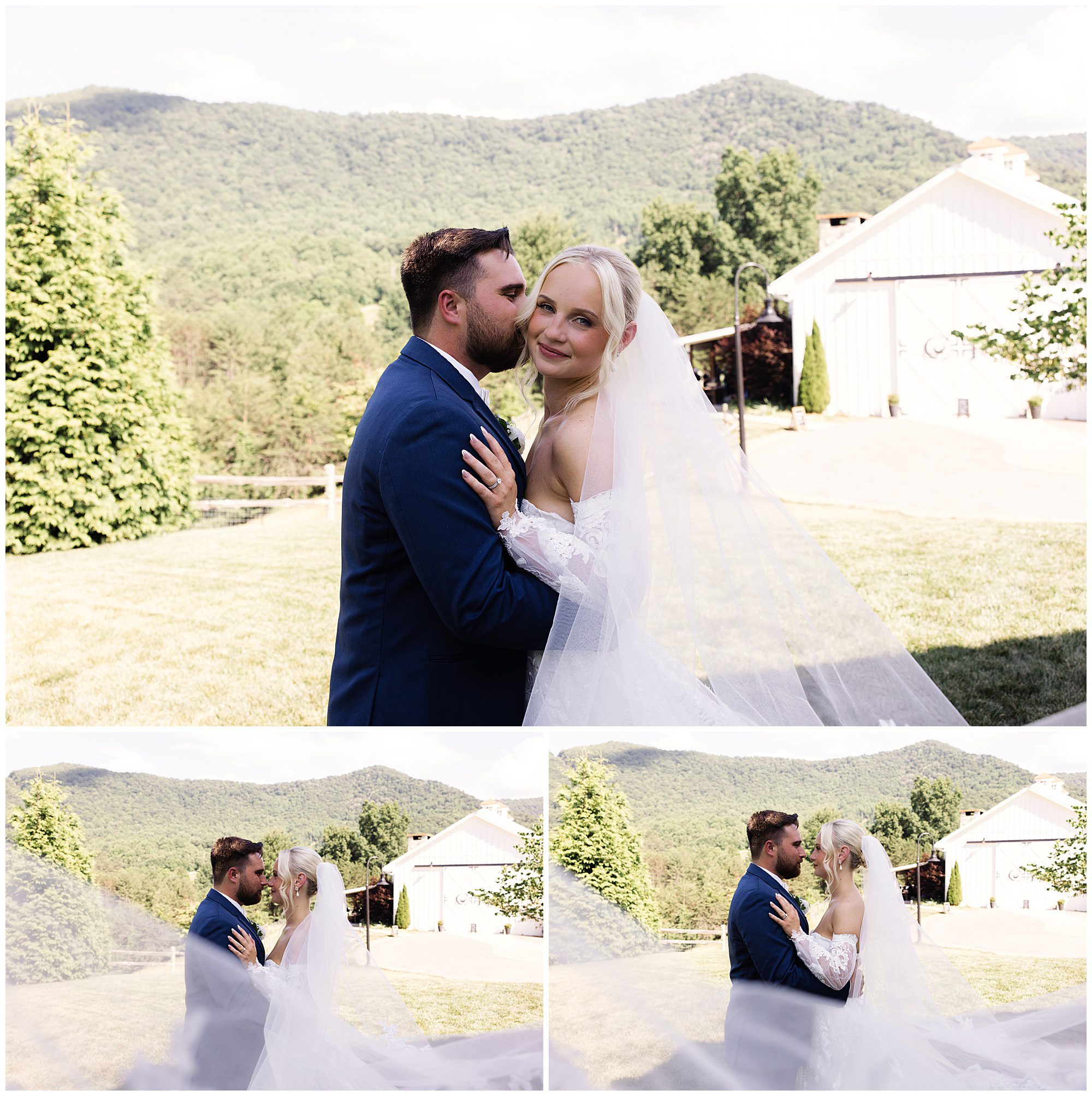 A couple dressed in wedding attire poses together outdoors on a sunny day with mountains and trees in the background. The bride wears a veil and gown, and the groom is in a blue suit.