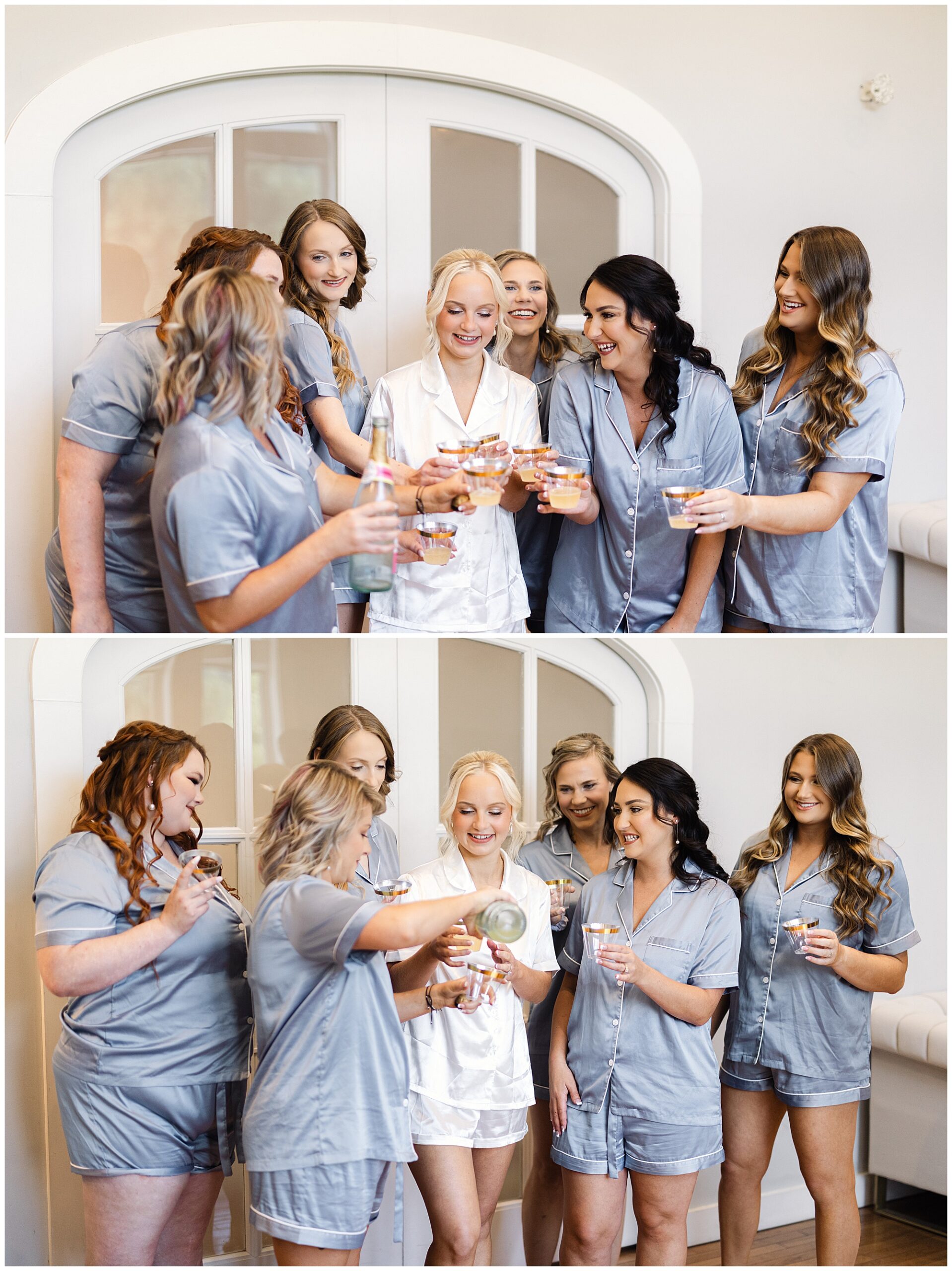 A group of women in matching pajamas are holding and pouring drinks as they stand together, smiling in front of a door.