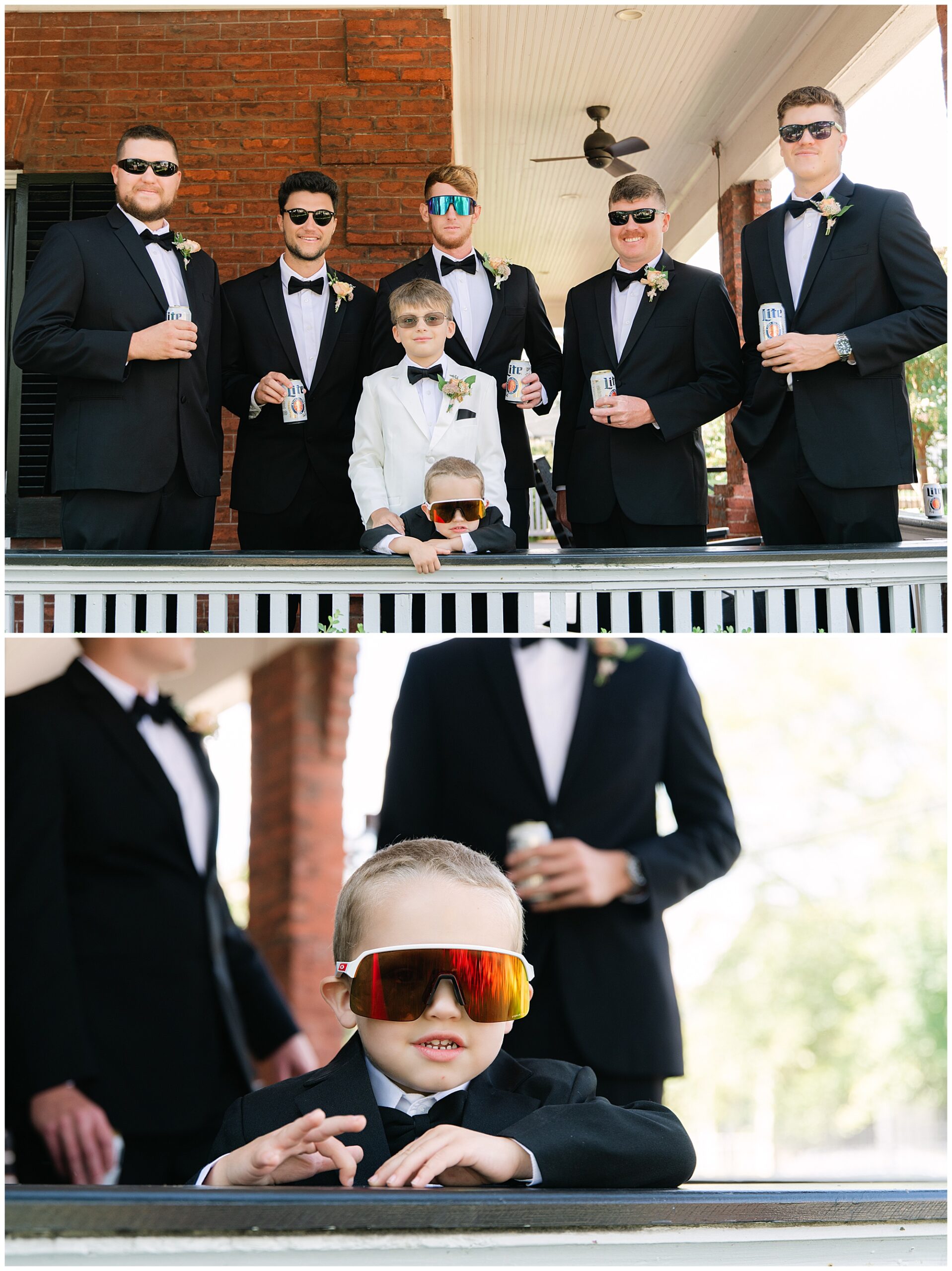 A group of men and a boy, all in formal black suits, stand outside a brick building. The boy in front wears large sunglasses and a white suit, holding a drink can. They appear relaxed and cheerful.