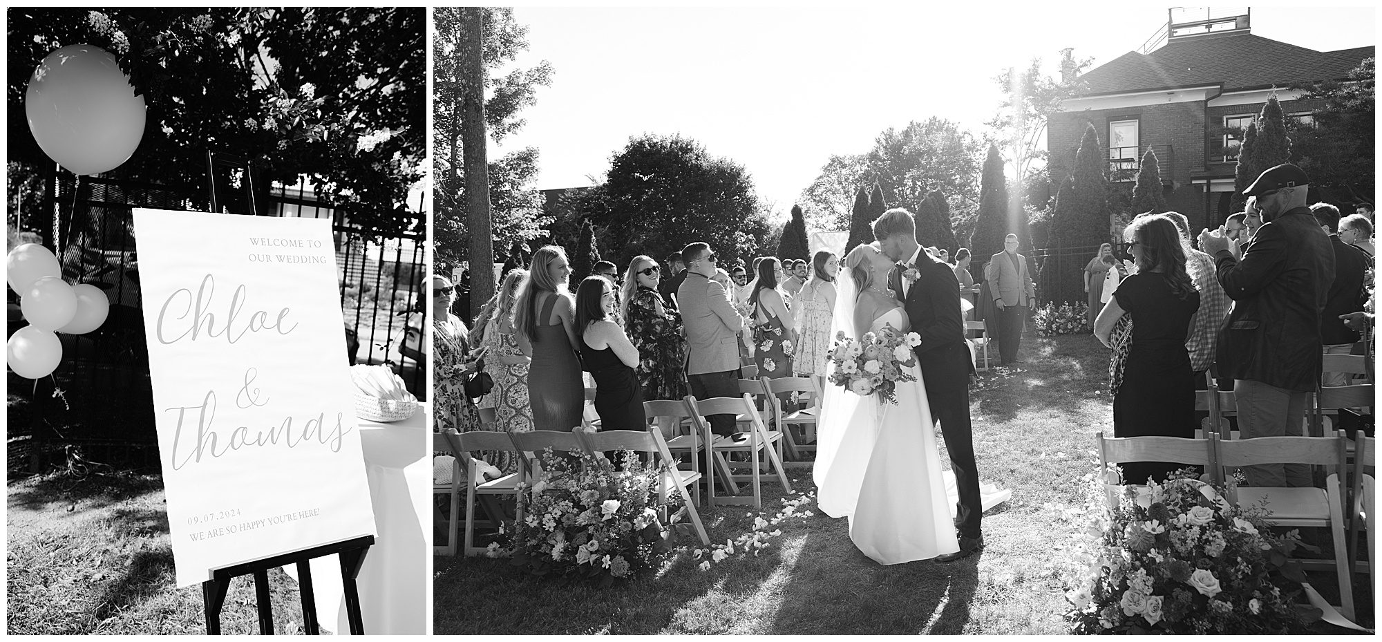 A black and white photo of an outdoor wedding shows a bride and groom kissing at the end of an aisle with guests seated on either side, and a sign with their names and wedding details on display.