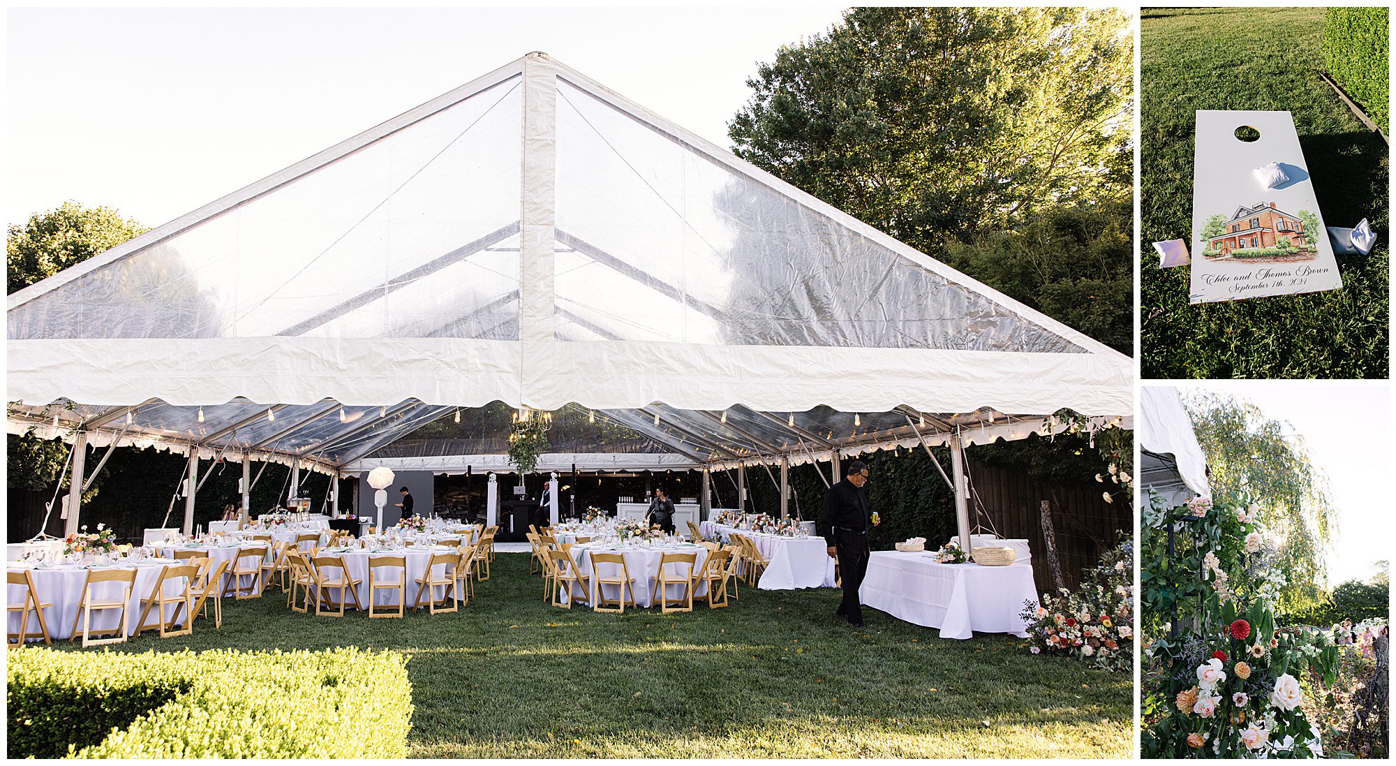 A wedding tent with clear roof panels set up with tables and chairs on a grassy lawn, a customized cornhole game board, and floral arrangements beside a wooden fence.