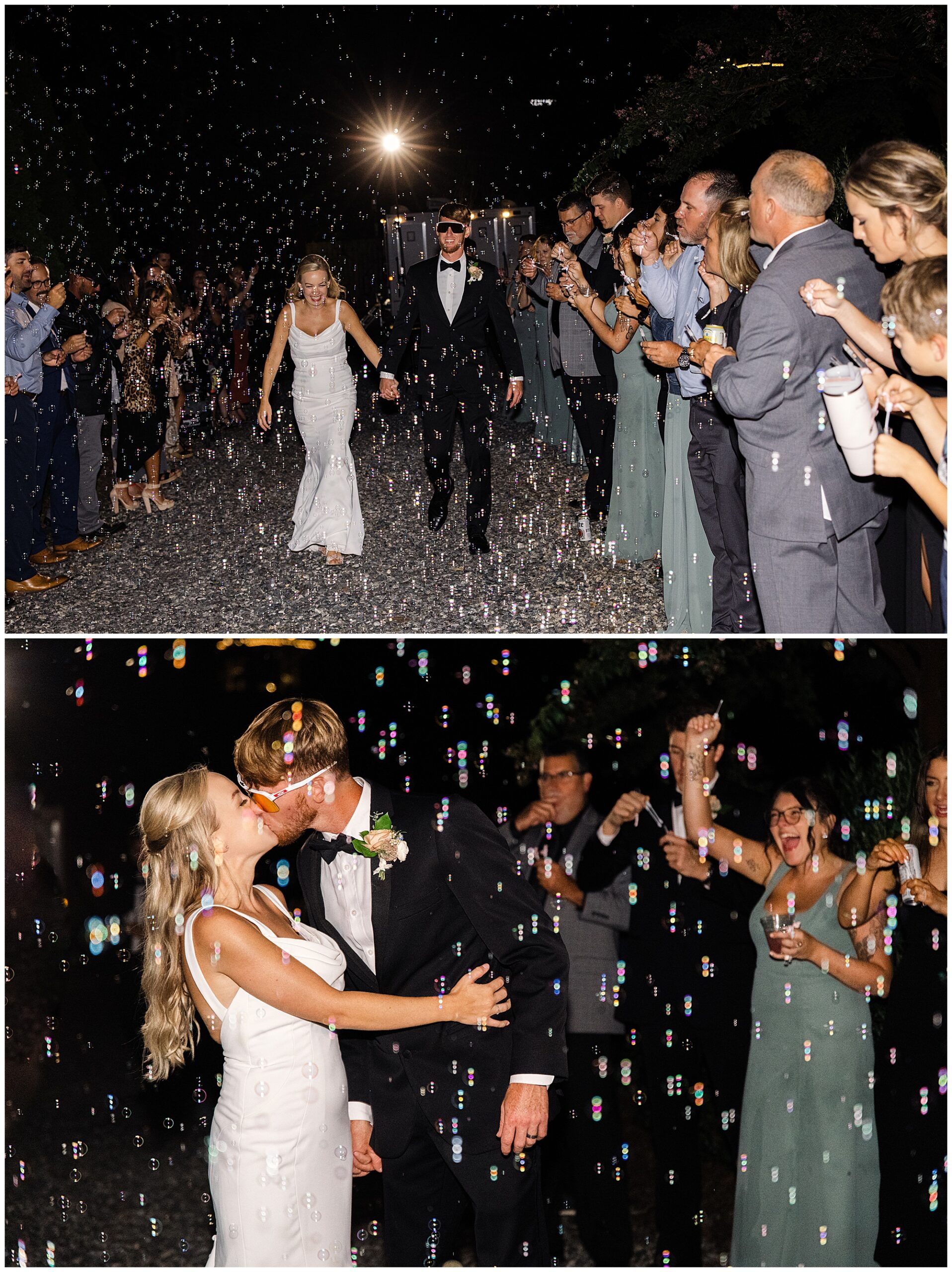 A couple in wedding attire walks through a line of guests blowing bubbles at night. The couple kisses while surrounded by bubbles.