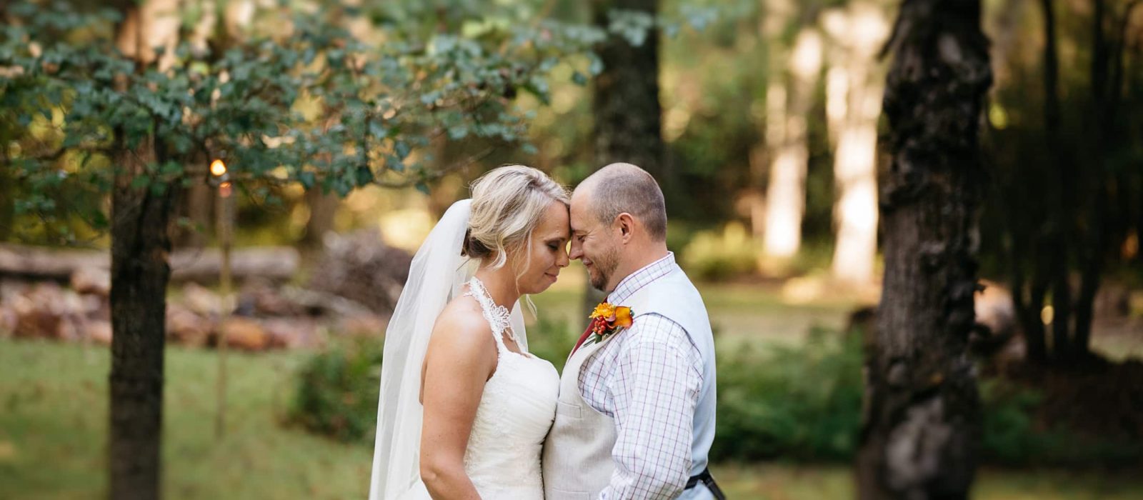 Bride and Groom holding hands at outdoor wedding in the fall